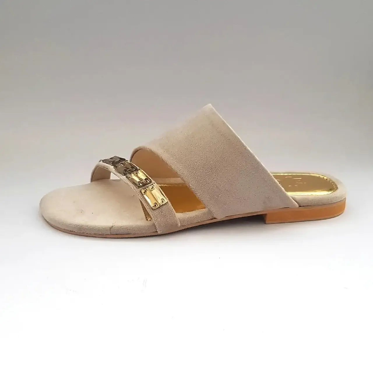 Beige sandal with a gold strap on a white background