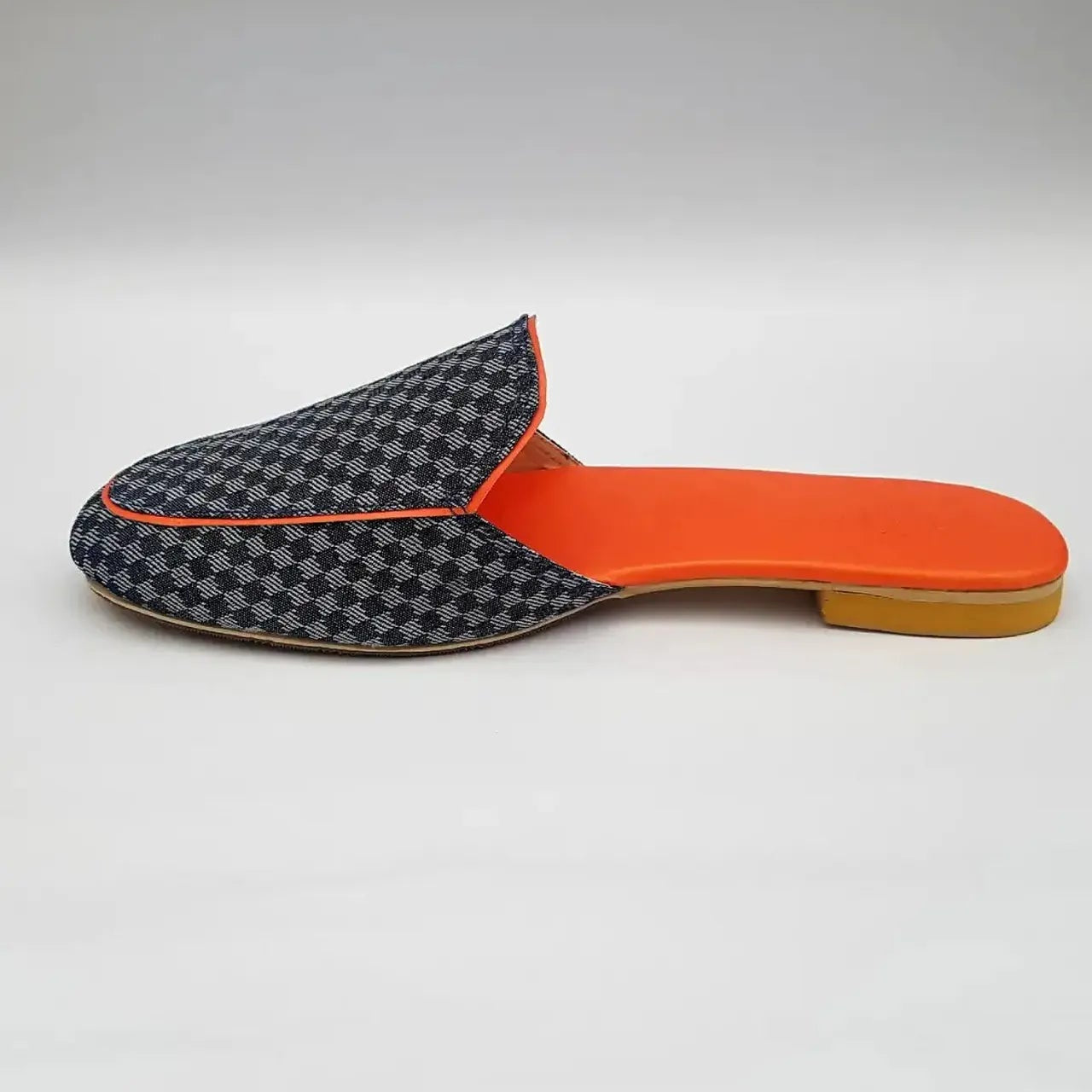 Slipper with checkered pattern and orange insole on a light gray background