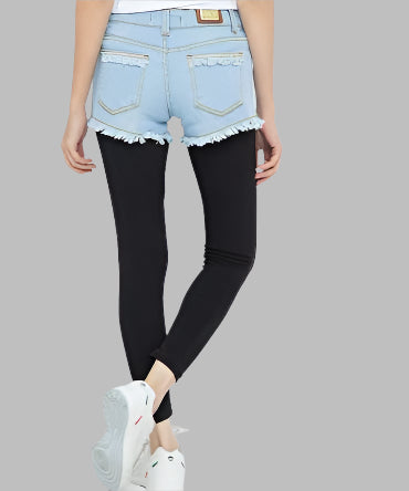 100% Cotton stretch ice blue denim frayed hot pants with signature logo insignia on pocket facing with frayed edges on pockets & legs.