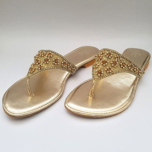 Golden flat slippers with stone embellishment