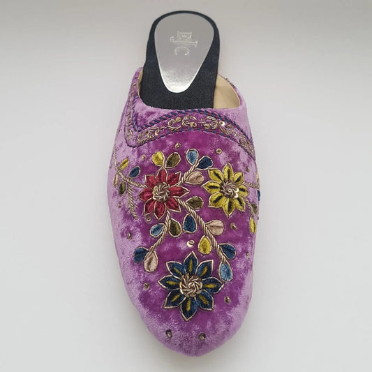Purple shoe with floral embroidery on a white background