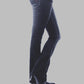 Dark blue jeans worn by a person on a gray background