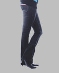 Dark blue jeans worn by a person on a gray background