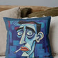 Decorative pillow with a stylized face design on a couch