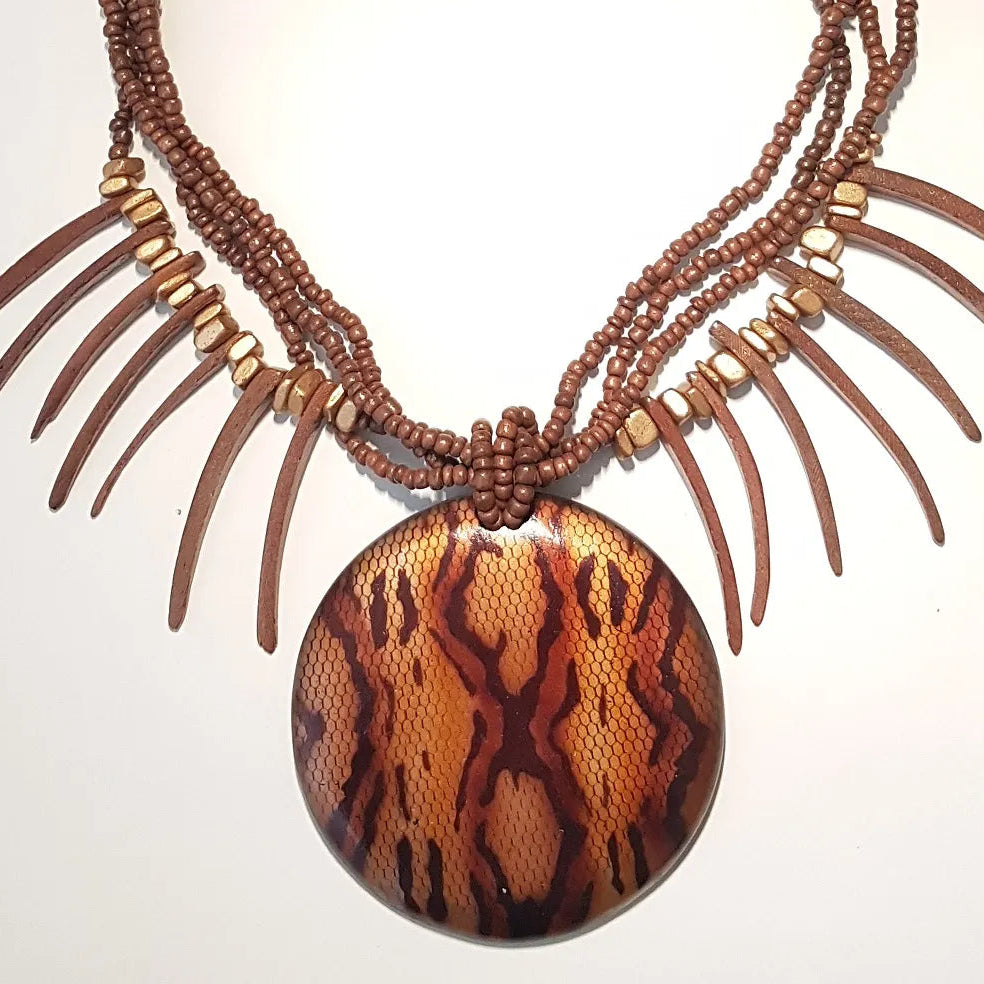 Necklace with a round, tiger-patterned pendant on a white background