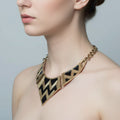 Gold and black chevron patterned necklace on a mannequin