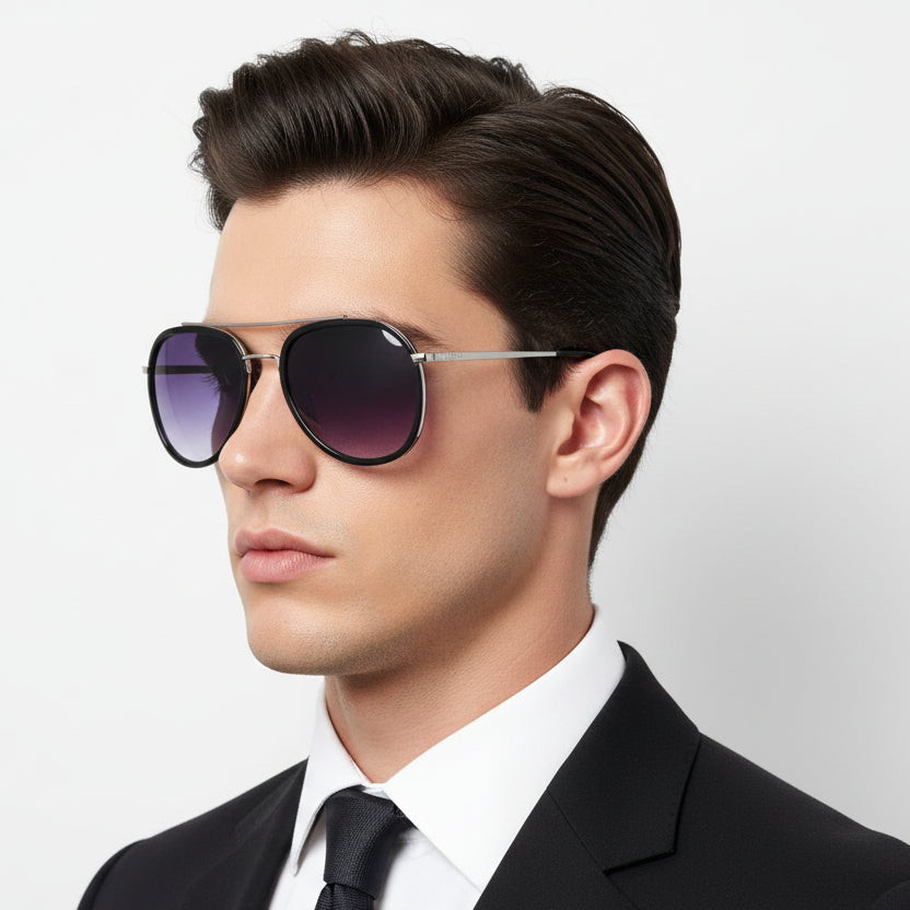 Sunglasses with purple lenses on a rock against a gray sky