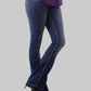 Person wearing blue jeans and a purple top on a gray background