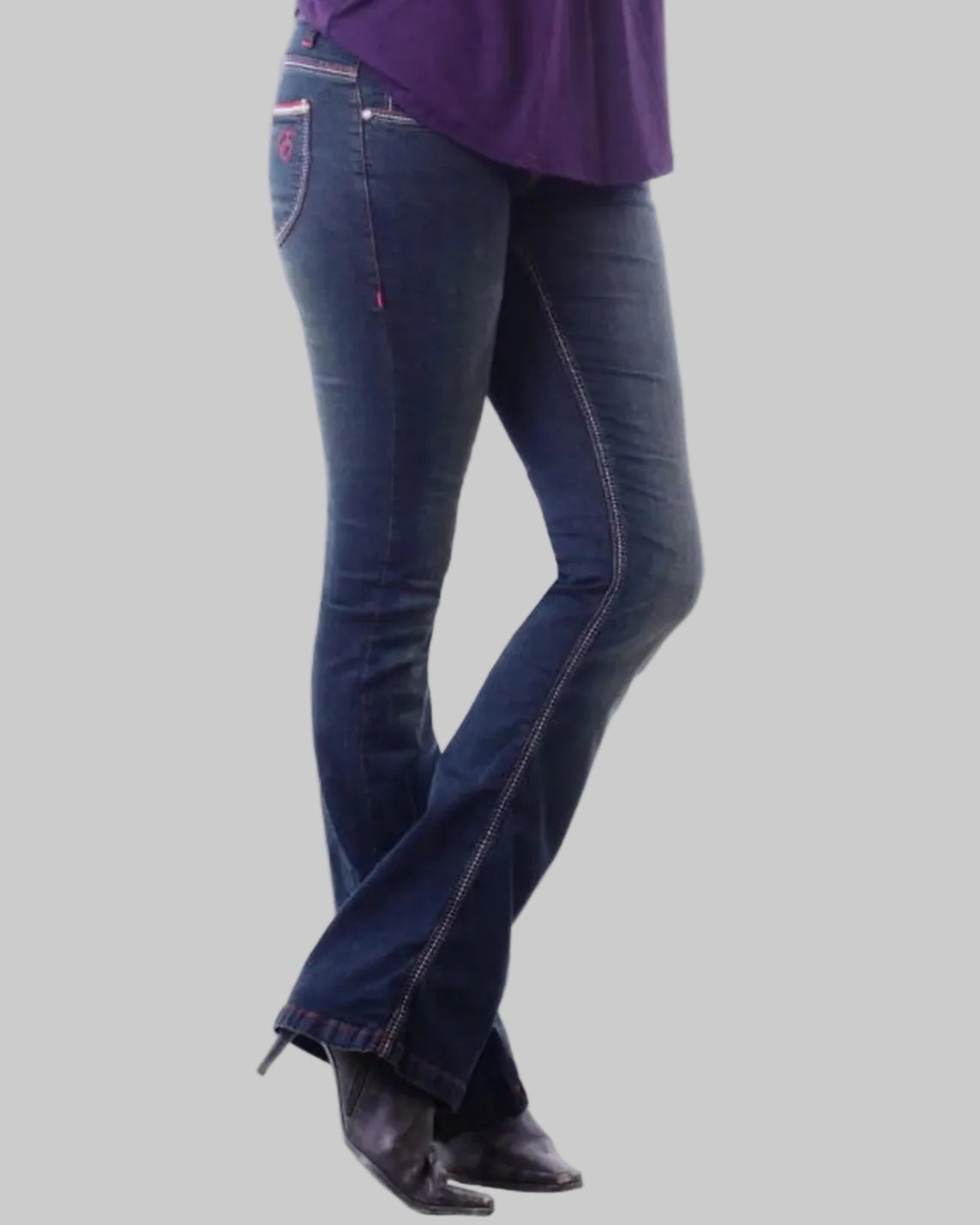 Person wearing blue jeans and a purple top on a gray background