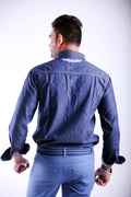 Man wearing a blue denim jacket and pants on a white background
