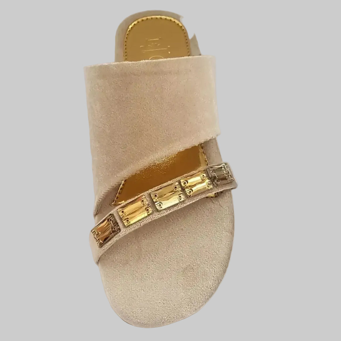 Beige sandals with gold straps on a white background
