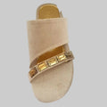 Beige sandal with gold embellishments on a white background