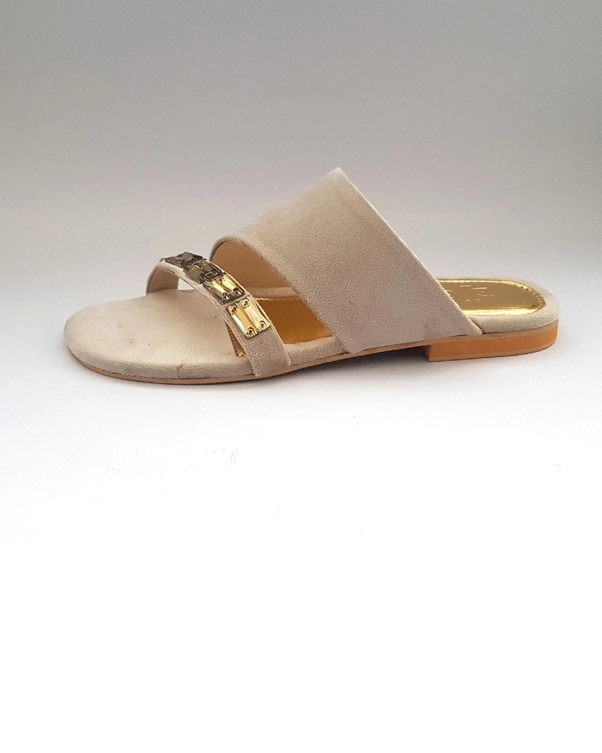 Beige sandal with a gold strap on a white background