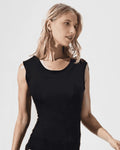 Woman wearing a black sleeveless bodysuit against a white background