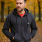 Man wearing a black hoodie with a logo in an autumn setting