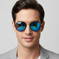 Sunglasses with blue reflective lenses and gold frame on a white background