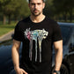 Man wearing a black t-shirt with colorful graphics and text, standing outdoors.