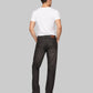 Man wearing a white t-shirt and black jeans on a gray background