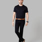 Man wearing a black t-shirt, black pants, and brown shoes on a gray background