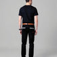 Man wearing black pants and a black shirt on a gray background