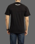 Person wearing a black t-shirt with a logo on the back against a gray background