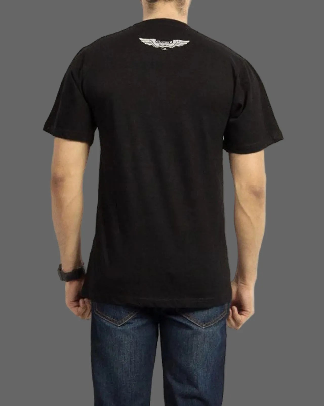 Person wearing a black t-shirt with a logo on the back against a gray background