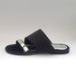 Black sandal with a decorative strap on a white background