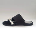 Black sandal with a decorative strap on a white background