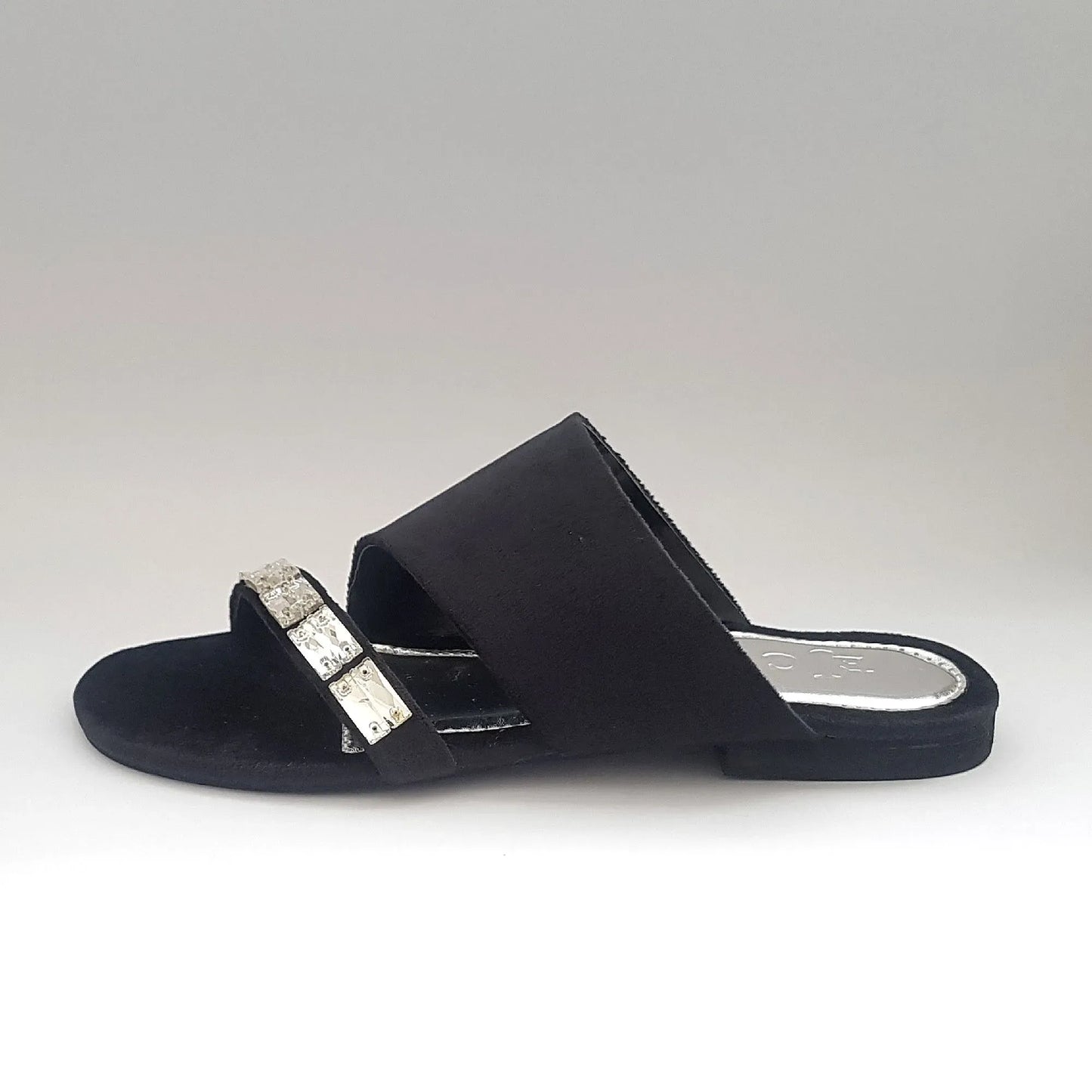Black sandal with a decorative strap on a white background