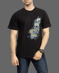 Person wearing a black t-shirt with a graphic design on a gray background