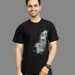 Person wearing a black t-shirt with a graphic design on a gray background