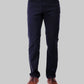 Person wearing black pants and brown shoes on a white background