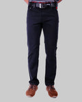 Person wearing black pants and brown shoes on a white background