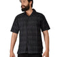 Man wearing a black patterned shirt on a white background