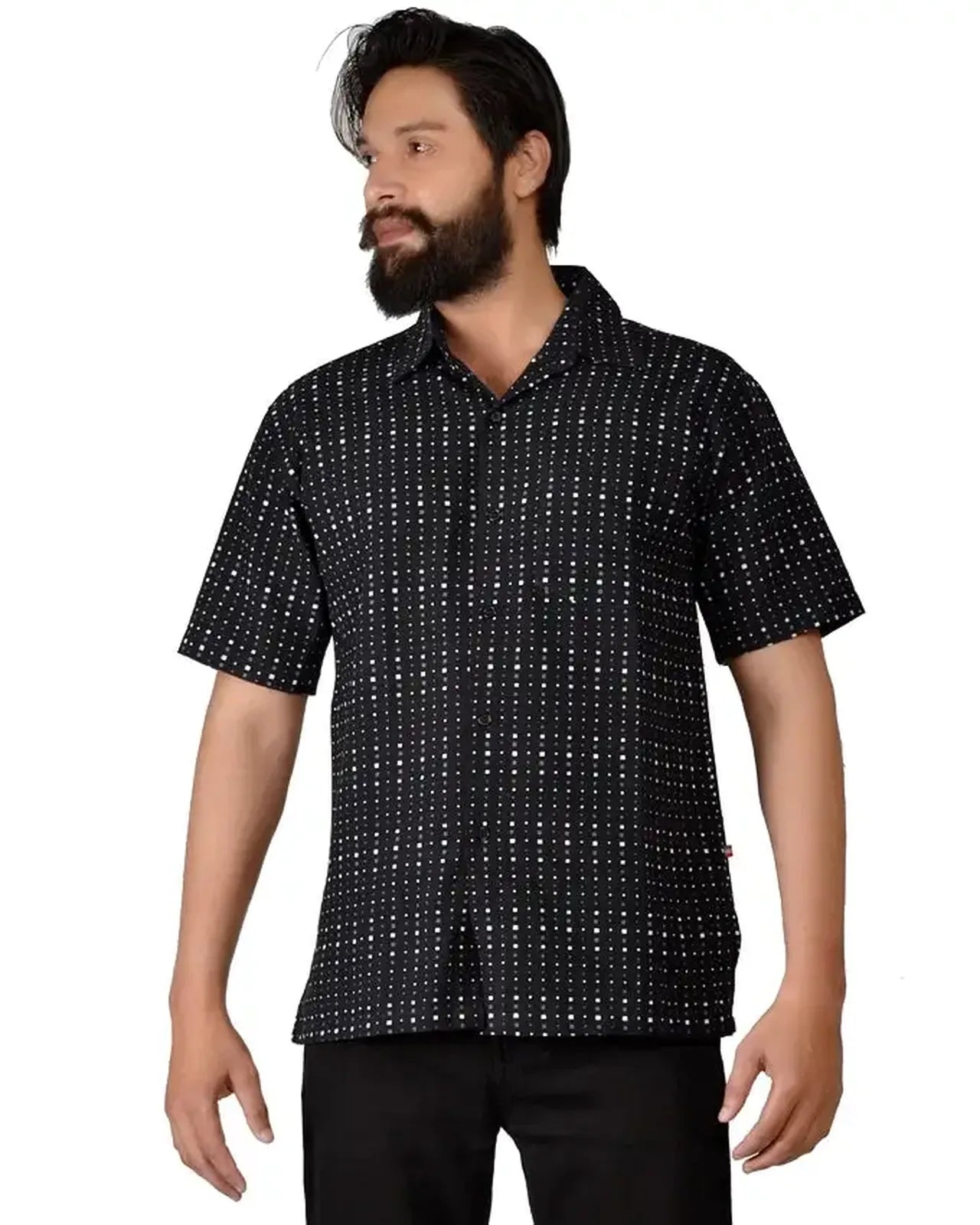 Man wearing a black patterned shirt on a white background