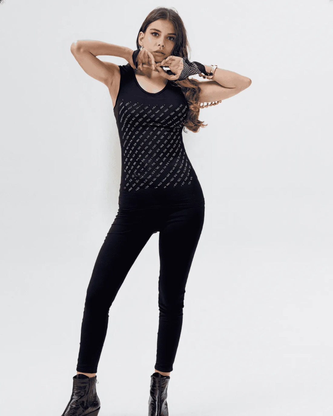 Person wearing a black outfit with geometric pattern on a white background
