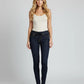 Woman wearing dark blue jeans and a white top on a gray background