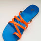 Blue sandal with orange straps on a light gray background