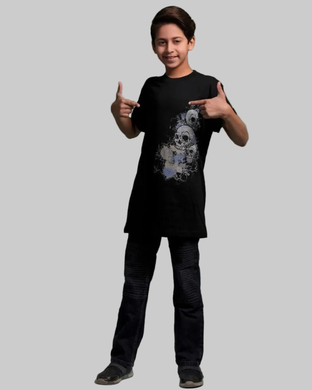 Person wearing a black t-shirt with a graphic design on a green background