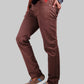 Brown pants worn by a person on a white background