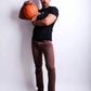 Man holding a basketball against a white background