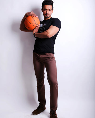 Man holding a basketball against a white background