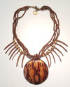 A brown wooden pendant necklace with multiple bead strings and an adjustable closure.