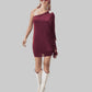 Woman wearing a burgundy one-shoulder dress and white boots on a white background