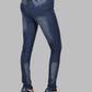 Blue jeans worn by a person on a gray background