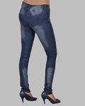 Blue jeans worn by a person on a gray background