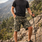 Man in hiking attire with a trekking pole on a mountain trail