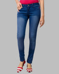 Blue jeans worn by a person on a gray background
