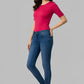 Woman wearing a pink top and blue jeans on a gray background