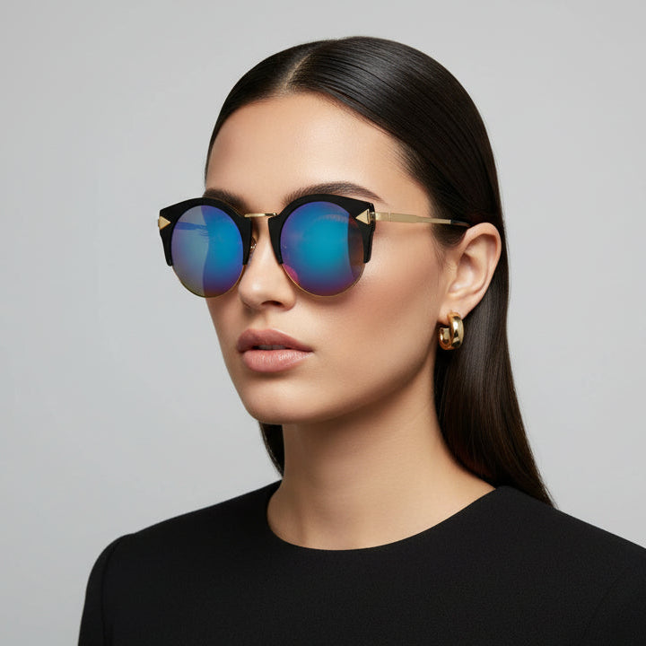 Woman wearing reflective sunglasses against a gray background
